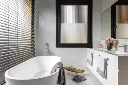 Baño moderno con bañera exenta y detalles de mármol — proyecto Casa Bosque Chico, por Mazzinghi Sanchez, en Garin
